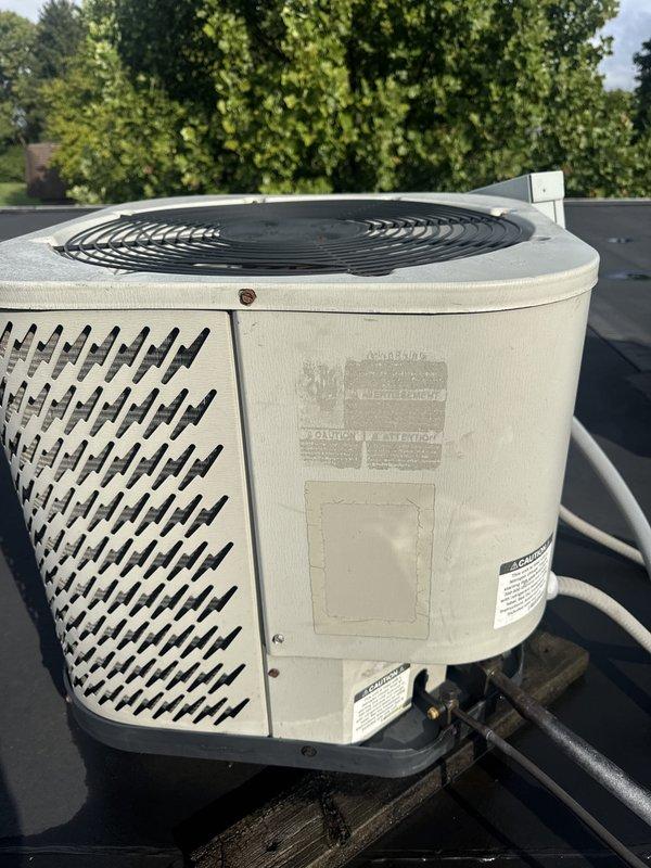 Responded to no cooling complaint at commercial property. Inspected rooftop condenser unit and found system operational upon arrival. Verified unit power supply, checked electrical disconnect, and confirmed compressor and condenser fan motor functionality. Documented equipment condition with exterior cabinet showing normal weathering consistent with outdoor installation. System restored to normal cooling operation.