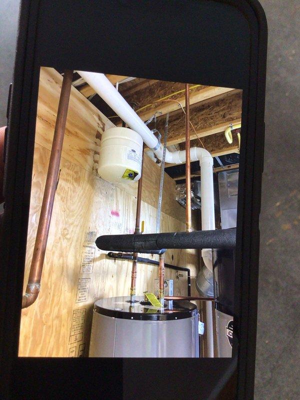 Replaced 75-gallon electric water heater holding tank on geothermal system. Disconnected and removed existing tank, installed new unit with proper copper piping connections, PVC discharge lines, and electrical wiring. Verified all plumbing connections for proper operation and system functionality upon completion.