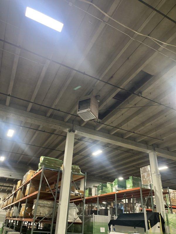 Conducted comprehensive site evaluation of multiple suspended heating units in commercial warehouse facility. Assessed ceiling-mounted HVAC equipment including evaporative cooling systems and heating units serving high-bay storage areas. Documented existing equipment conditions, configurations, and mounting systems for preparation of heating system replacement estimate.