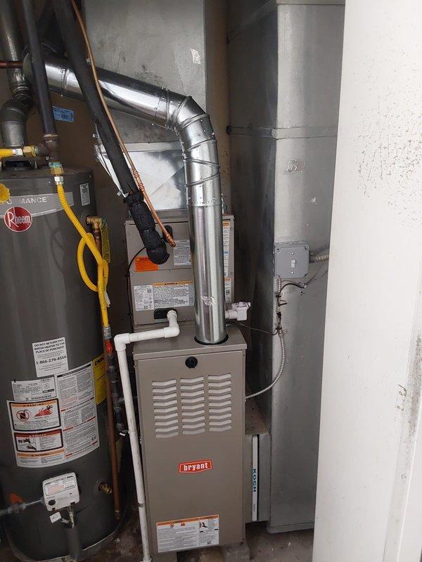 Completed full HVAC system replacement at commercial property, relocating outdoor condensing unit away from dryer vent for proper clearance and ventilation. Installed new Carrier condensing unit (model 800SB36070) on composite pad with proper electrical disconnect and whip, new Bryant furnace (model GA4SAN524), and Carrier evaporator coil (model CVAVA2414) with complete ductwork connections. Removed and disposed of existing equipment per EPA refrigerant recovery specifications, installed solid disconnect box, obtained necessary permits, and verified all components operating within manufacturer specifications upon system startup.