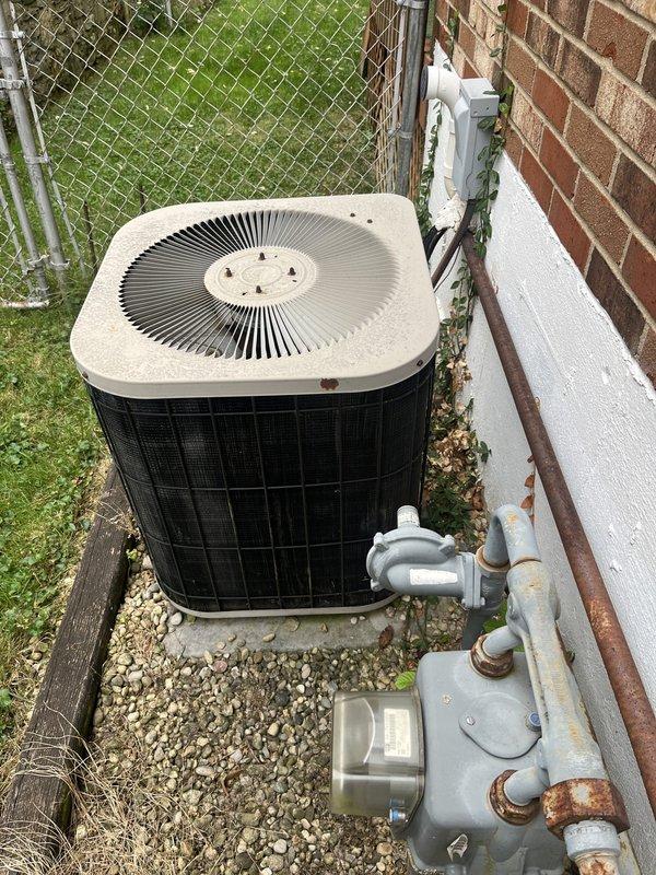 Performed estimate for replacement of 30-year-old residential air conditioning system utilizing R22 refrigerant. Unit was previously serviced for low refrigerant charge, indicating potential system leaks or efficiency loss common in aging equipment. Evaluated outdoor condenser unit positioned on gravel pad adjacent to structure, noting overall condition and accessibility for replacement. Discussed available discount programs and provided comprehensive replacement options for upgrading to modern, environmentally-compliant refrigerant system.