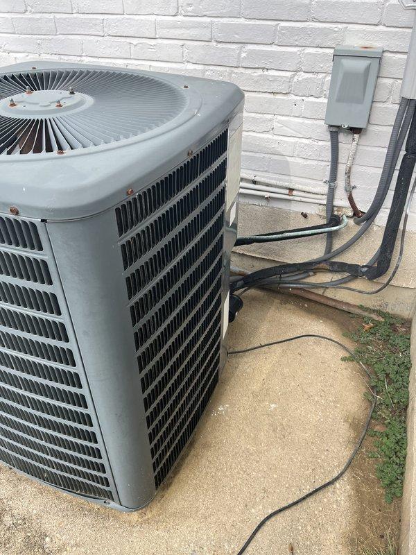 Conducted comprehensive estimate for replacement of 28-year-old HVAC system including outdoor air conditioning unit and indoor boiler with circulation pumps. Documented existing equipment condition through photographs showing aged copper piping with natural patina, multiple red circulation pumps, water heater/boiler unit, and outdoor condenser unit with functional louvers and grille, all systems currently operational but at end of expected service life.