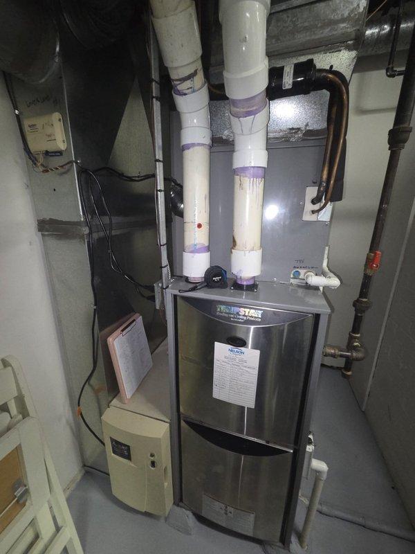 Provided replacement estimate for three gas furnace units: two Tempstar units located in the basement and one Bryant unit installed in the garage. Evaluated existing HVAC equipment including vertical furnace configuration with PVC venting system, associated ductwork, electrical connections, and refrigerant line sets. Documented current system specifications and provided comprehensive replacement options for all three furnace units to address equipment age and efficiency requirements.