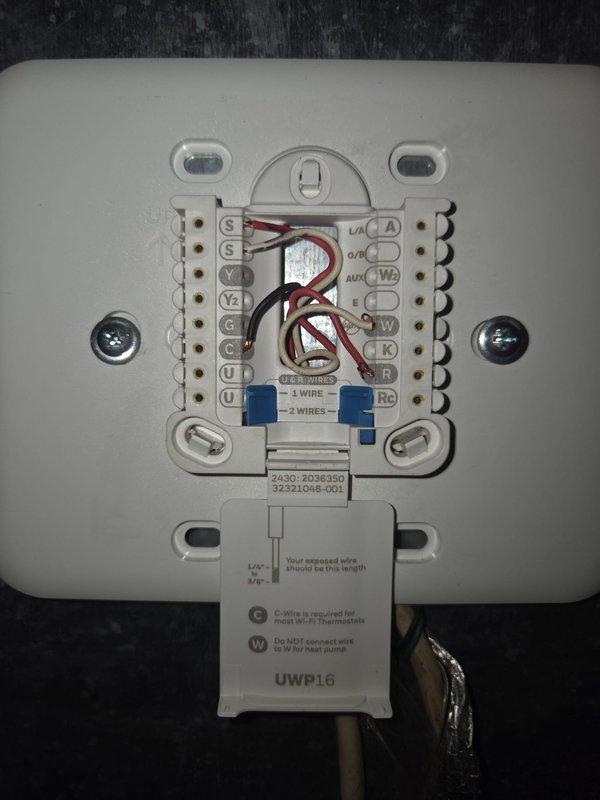 Conducted comprehensive assessment of existing Carrier HVAC system for complete replacement estimate. Evaluated current furnace/air handler unit located in mechanical room, documented thermostat wiring configuration on UWP16 model thermostat including multi-wire setup with proper terminal connections, and photographed existing equipment layout including flexible ductwork connections for replacement planning purposes.