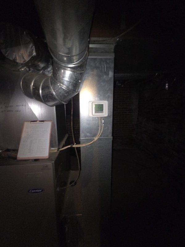 Conducted comprehensive assessment of existing Carrier HVAC system for complete replacement estimate. Evaluated current furnace/air handler unit located in mechanical room, documented thermostat wiring configuration on UWP16 model thermostat including multi-wire setup with proper terminal connections, and photographed existing equipment layout including flexible ductwork connections for replacement planning purposes.