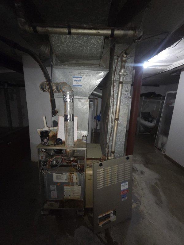 Performed a replacement estimate for a basement upflow Bryant 110k BTU gas furnace with a 3-ton single-phase condenser/heat pump. Measured the existing furnace, plenum, and ductwork (8x16, 8x15, and two 6" runs) and documented the 4" metal flue, brick wall construction, and floor plastic drain. Noted that approximately 6 feet of flue must be replaced, the gas line requires 1 foot of replacement with a union installed, a shut-off switch must be added, and the air filter and condenser base should be replaced, while the humidifier and thermostat will be retained. Also documented damp, stained concrete around the furnace base, and recorded 3/4" x 3/8" refrigerant line sizes.