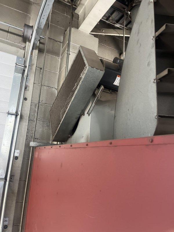 Performed an on-site estimate for replacement of a ceiling-mounted, oil-fired unit heater (Clean Burn CB 3500) located in a commercial maintenance shop. Inspected the unit, burner assembly, flue connection, ductwork, and associated piping and electrical conduit, and documented existing conditions with photographs to support replacement scoping. The unit showed general wear and dust accumulation, with no evidence of major corrosion or damage.