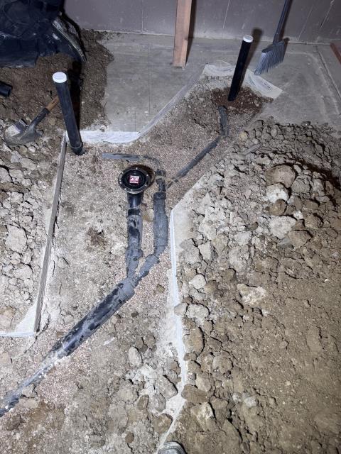I replaced 4” piping under the slab to connect with the existing 3” vertical drop. The old basement bathroom group piping was removed and disposed of appropriately. New drain lines were routed for the underground kitchen sink, laundry connection, and emergency floor drain, including a mechanical studor vent. Piping for the basement toilet, lav sink, and shower was installed, with fixture locations confirmed with the homeowner. The main level powder room toilet drop was repiped for proper slope, a “wye” was added for a future shower line, and a vent line was capped as requested. All new piping was bedded in pea gravel and sloped correctly. The work was reviewed and approved by the customer and passed city inspection.