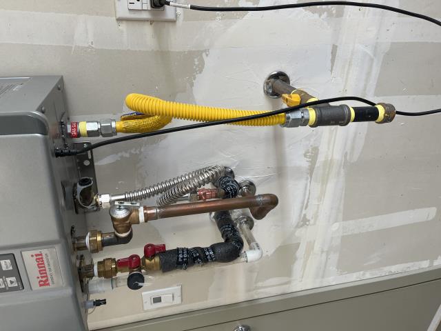 Rinnai tankless water heater leaking from cold side inlet service valve brass union due to a crack. 
Removed service valve & installed a temporary water heater flex line until new service valve is ordered &  installed.