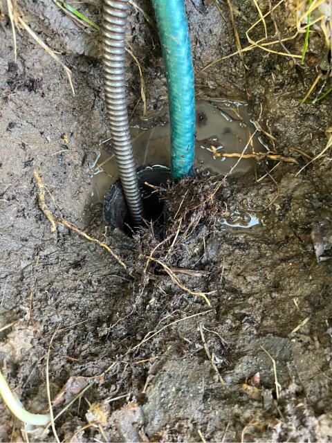 Arrived to find mainline backed up towards street 
Ran mainline cable down clean out 
Ran cable 5 feet to get line cleared 
Ran cable out 20 feet before pulling back roots on cable and blade 
Ran water down clean out to test 
Flushed toilets to test 
The mainline is functioning properly at this time 
