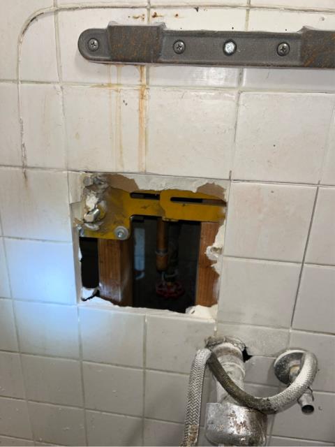 I removed the sink in the women’s restroom and cut open the wall. I found a gate valve that went straight to the outside wall hose bib that was leaking. I shut the gate valve off and found the leak outside had stopped. I advised the onsite maintenance staff that we’d like to cut the pipe and cap it off inside the wall, but they didn’t want us to do that. The on site maintenance staff asked us to just leave the valve shut off and cover it up with an access panel so they could turn the water back on if they needed to.
