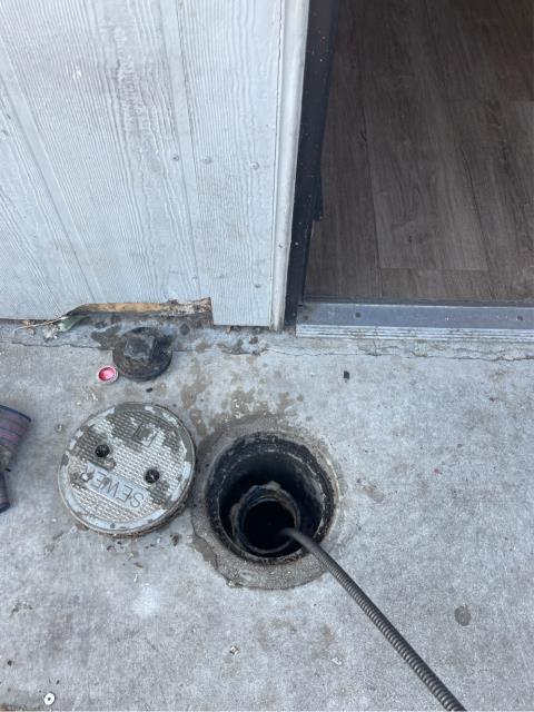 I was called to unclog a sewer main line. I ran a snake/blade down the line to find the blockage, which was a paper towel. I pulled out the paper towel and flushed all the toilets, urinals, and basins to test the line. All is flowing at this time. 