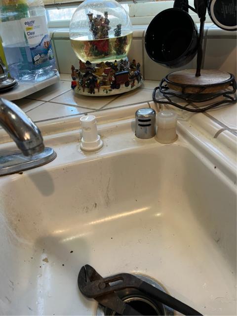 Arrived to find the air gap on the kitchen sink backing up onto the top of the kitchen sink and leaking into the cabinet below. 
  Removed the hose from the air gap to the garbage disposal and removed a lot of grease and food debris from the hose. 
  Removed the old air gap and installed a new one into its place. 
  Filled and drained the dishwasher again. Found the air gap functioning as it should be and the dishwasher draining without issue at this time. 