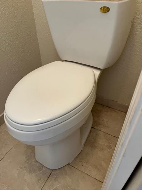 Pulled and reset their back bathroom toilet with our provided wax ring and shims. 
  Found the flange was higher on the right side and would need to be replaced in order to fix the toilet being higher on the right side than the left and too high for the toilet to seat onto the ground properly.  
  Tried to gain authorization from the owner to change out the flange. They chose to leave it as is at this time. 
  Had to use 14 shims, a set of toilet caps, and a 3” wax ring to reseat the toilet. 
  Filled and flushed the toilet multiple times to test. It’s functioning without issue at this time.