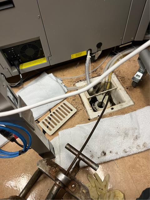  Ran a junior snake into one of the clogged floor sinks and got both of them to drain down about 50 feet into the line after getting stuck in the line multiple times. 
 Pulled back thick brown rusty sludge on the blade and cable multiple times before the line unclogged. 
  Ran water into the drains to test. They’re draining at this time.  
