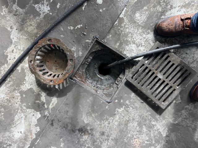 I was called to the floor drain in the mechanic room was clogged with grease and sludge. I removed the floor drain covers and removed the sludge/grease. I used a water hose to clean out the drain for 15 minutes. I also ran 15 gallons of water down the drain to ensure it was working properly.