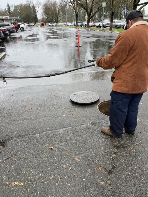 Ran the hydro jetter into the manholes in the driveway next to the science building and got them both flowing after breaking loose a ball of paper towels, wipes, and other debris from the line. 
  Ran water into the manholes to test. The sewer line is flowing at this time. 
