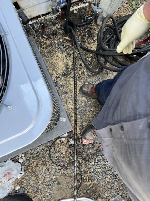 I arrived at the scene to find a clogged sewer line under unit 64. I had to remove the 3" abs union 90 from the drain to access the sewer line. I ran a mainline snake with a 3" grease cutting double blade into the 3" drain under the unit and got the line to flow about 90 feet into the line after fighting through a lot of rough pipe. I pulled back grease and hair on the blade and cable. I ran water into the line from my hose to test, and the sewer line is now draining.