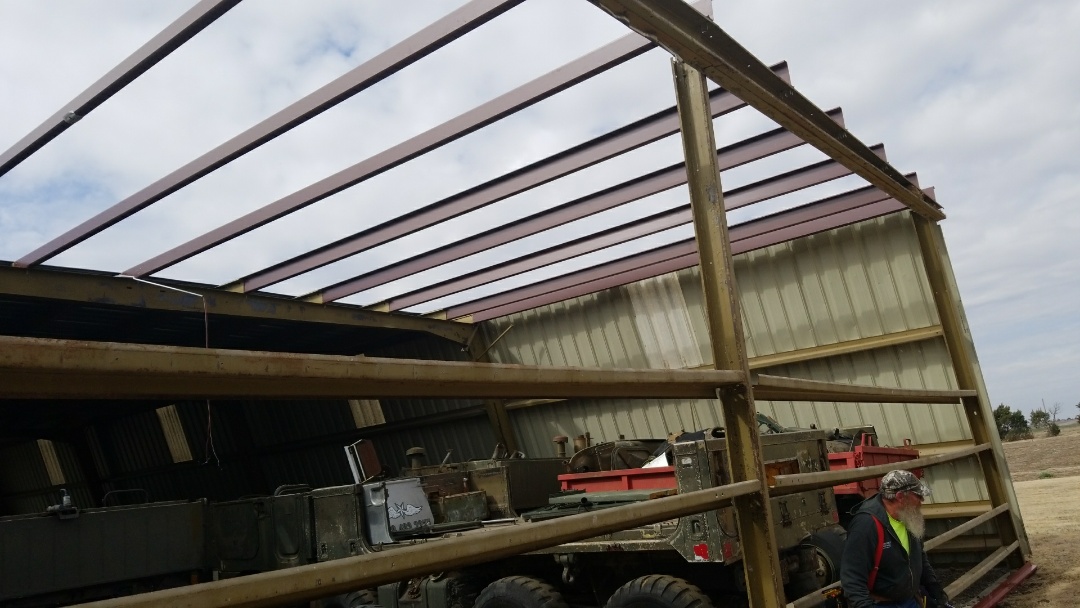 Brownell, KS - Removing and replacing wall panels and roof panels. New roof purlins from a wind blow off. Brownell, KS - Removing and replacing wall panels and roof panels. New roof purlins from a wind blow off.