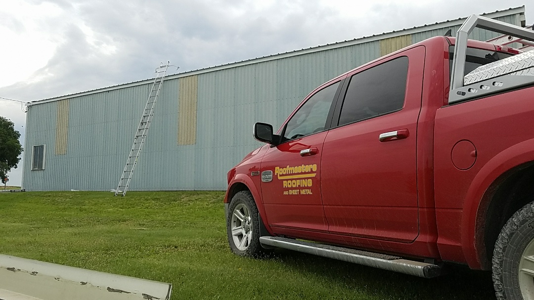 Morland, KS - Installing new metal roof on a machine shed impacted by the recent hail storms. Morland, KS - Installing new metal roof on a machine shed impacted by the recent hail storms.
