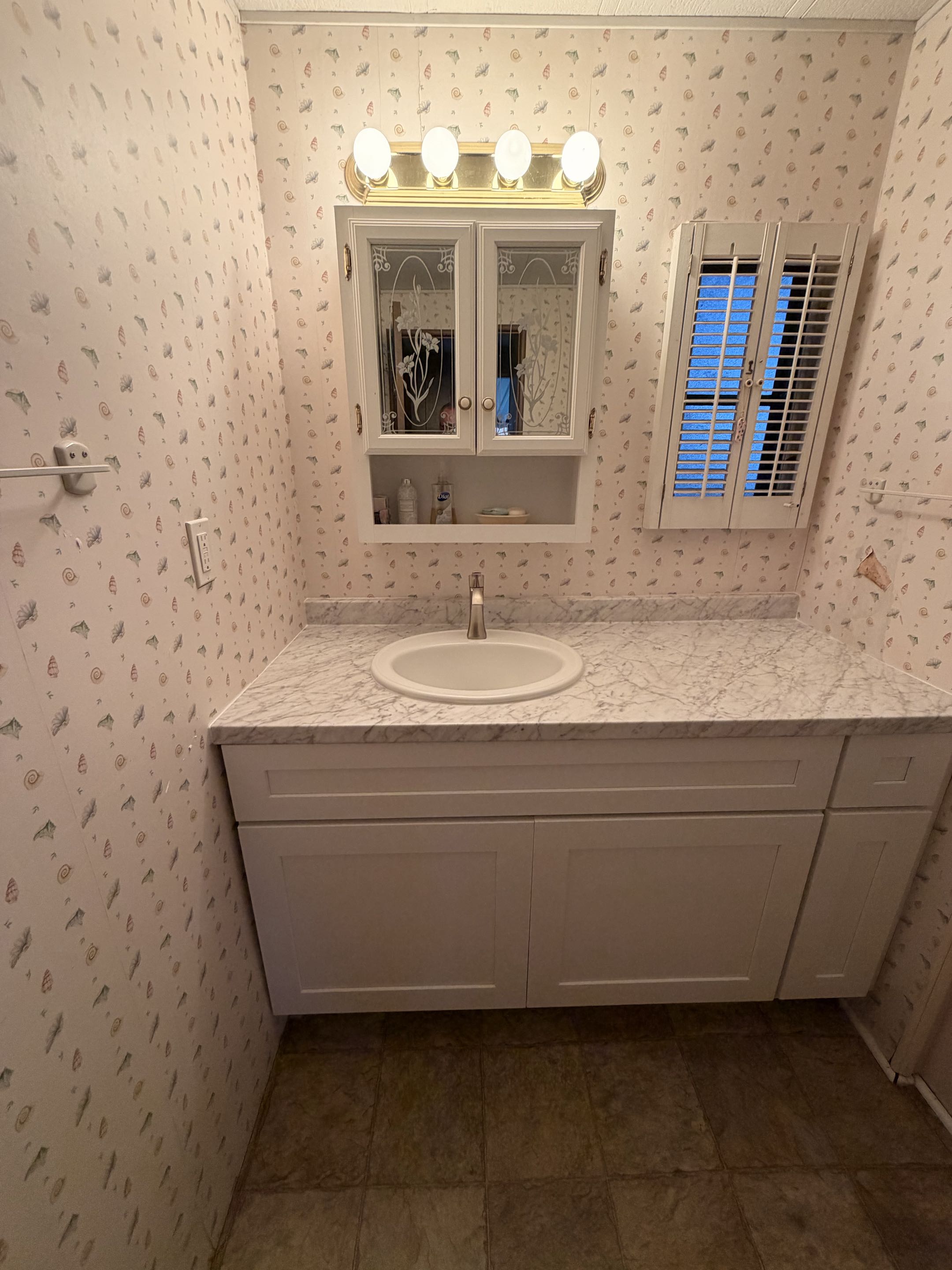 Completed final phase of repipe and installation of new kitchen cabinets, top with a Kohler drop in oval sink and Moen Voss brushed nickel single lever faucet. 
