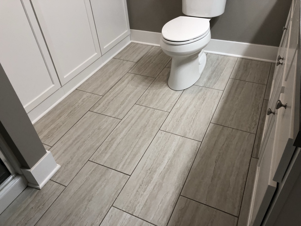 Grandville, MI - Installed new ceramic tile in bathroom. After water damage from toilet supply line. Removed old water damage laminate and replaced with upgraded ceramic floor tile. Grandville, MI - Installed new ceramic tile in bathroom. After water damage from toilet supply line. Removed old water damage laminate and replaced with upgraded ceramic floor tile.