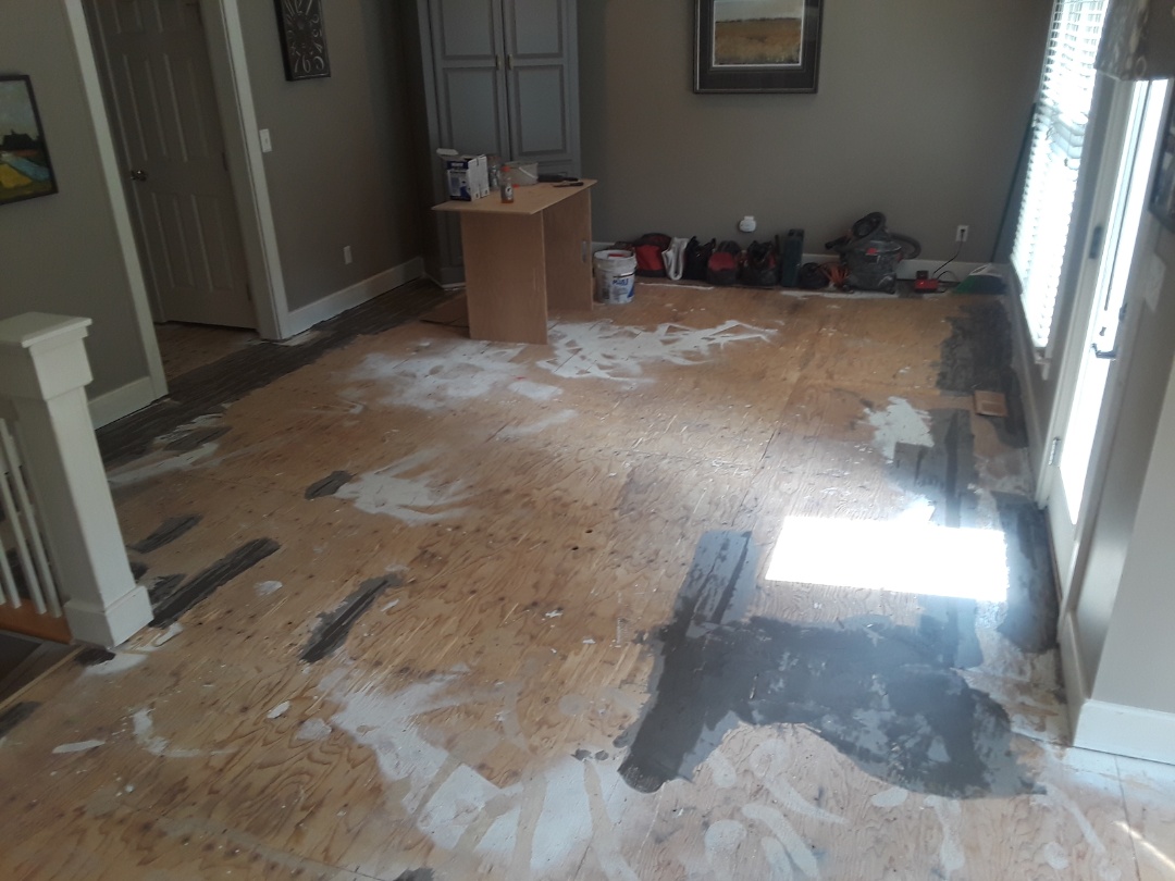 Cannon Township, MI - Finally finished with the floor prep. The dark grey is floor patching compound. The sub floor was damaged by glue used for the previous hardwood floor. Cannon Township, MI - Finally finished with the floor prep. The dark grey is floor patching compound. The sub floor was damaged by glue used for the previous hardwood floor.