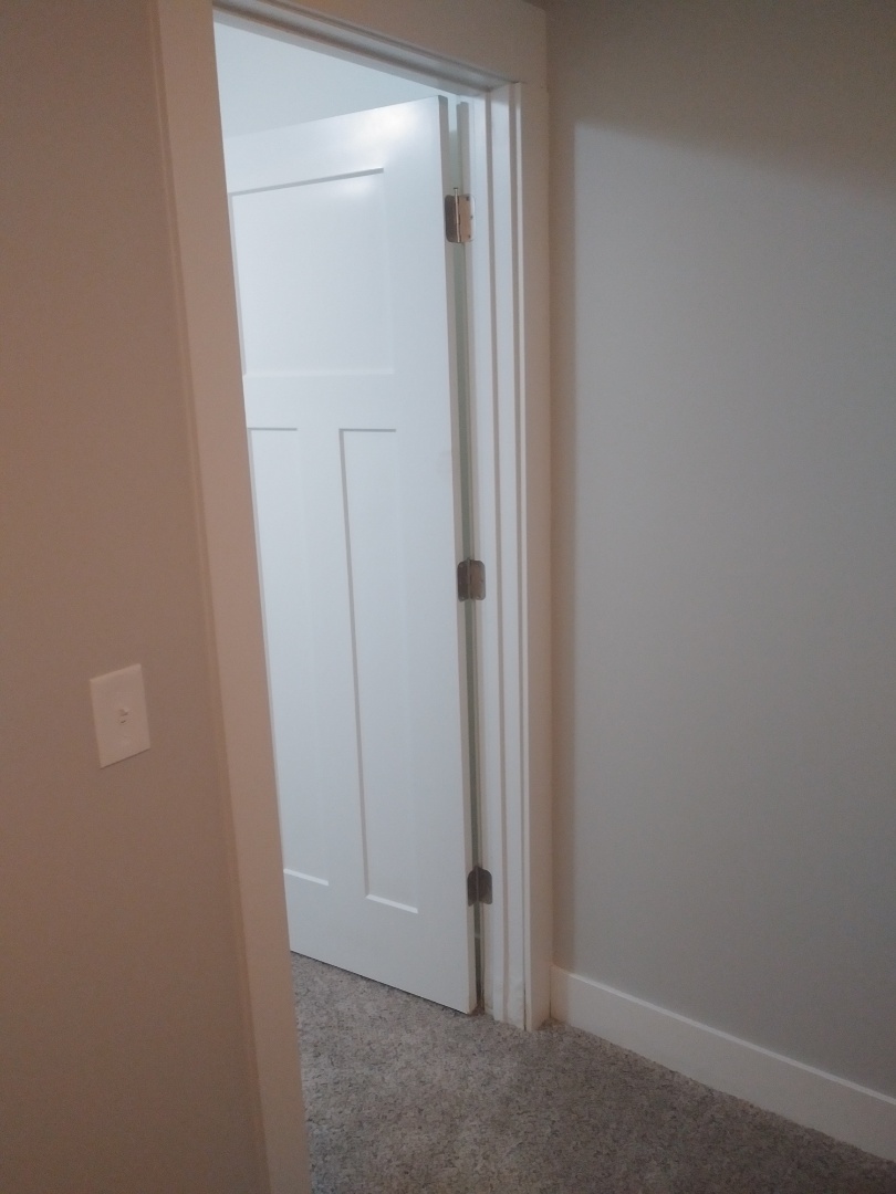Hudsonville, MI - About to remove a water damaged door caused by a foundation leak Hudsonville, MI - About to remove a water damaged door caused by a foundation leak