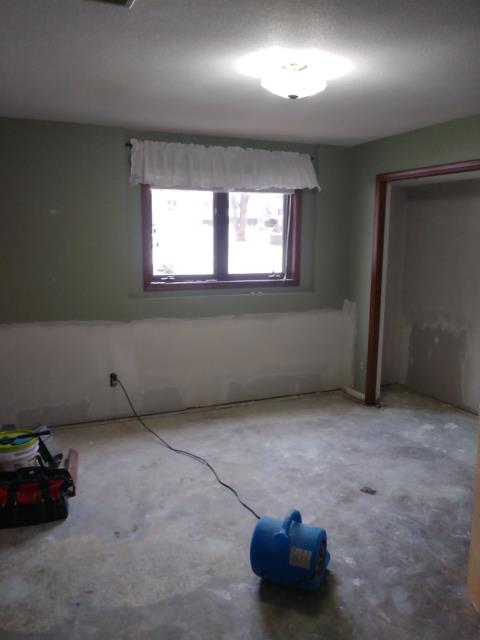Grand Rapids, MI - Damaged floor from window leak. Drying water on floor. Grand Rapids, MI - Damaged floor from window leak. Drying water on floor.