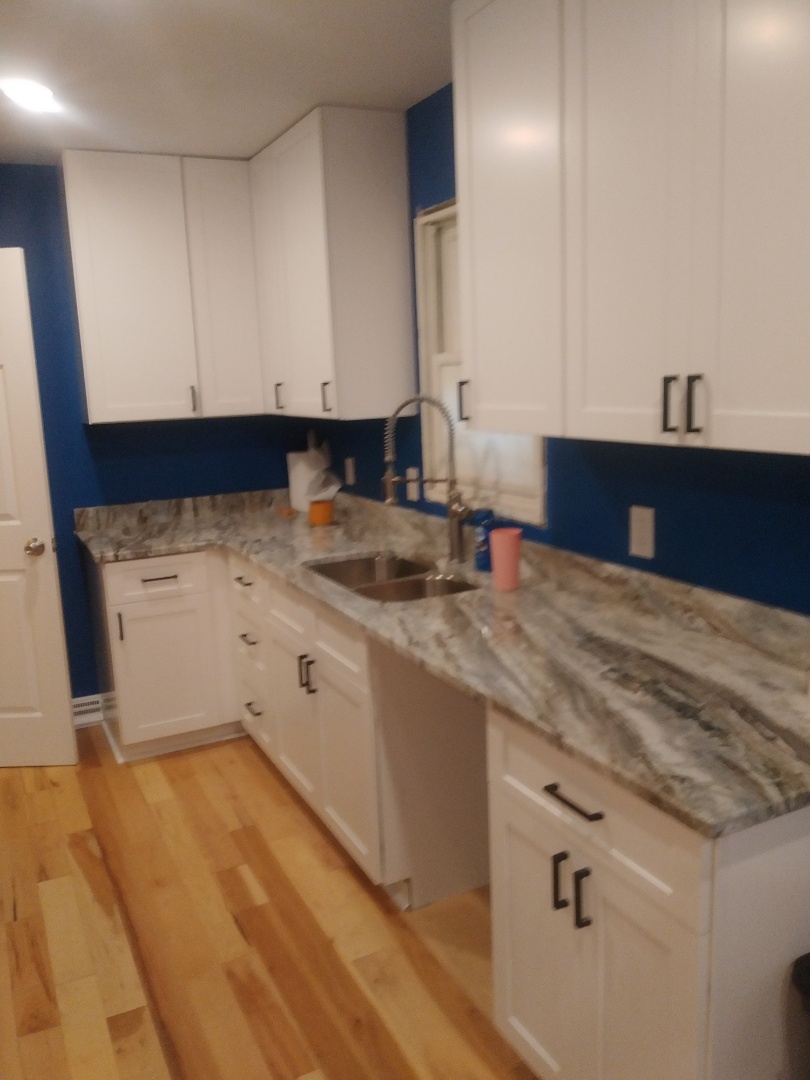 Grand Rapids, MI - New hardware on new cabinets. Along with new quartz countertop and new sink. Grand Rapids, MI - New hardware on new cabinets. Along with new quartz countertop and new sink.