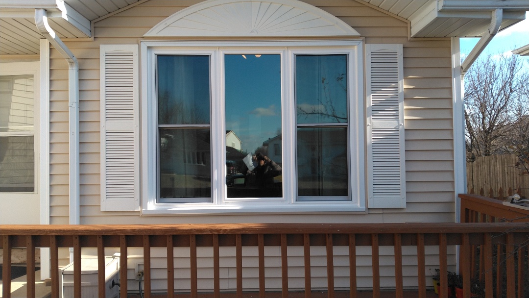 New Midway Hawthorne windows and sliding glass door.  Light oak interior, white exterior, triple pane glass in the front of the home. 