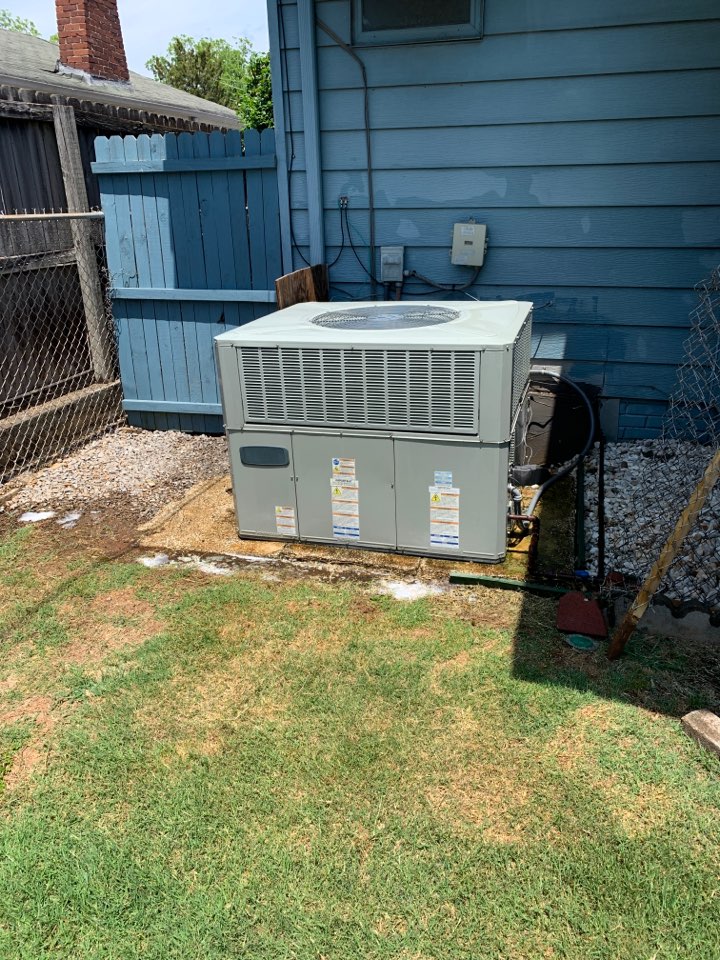 One Source doing a maintenance on an air conditioner in Fairview.