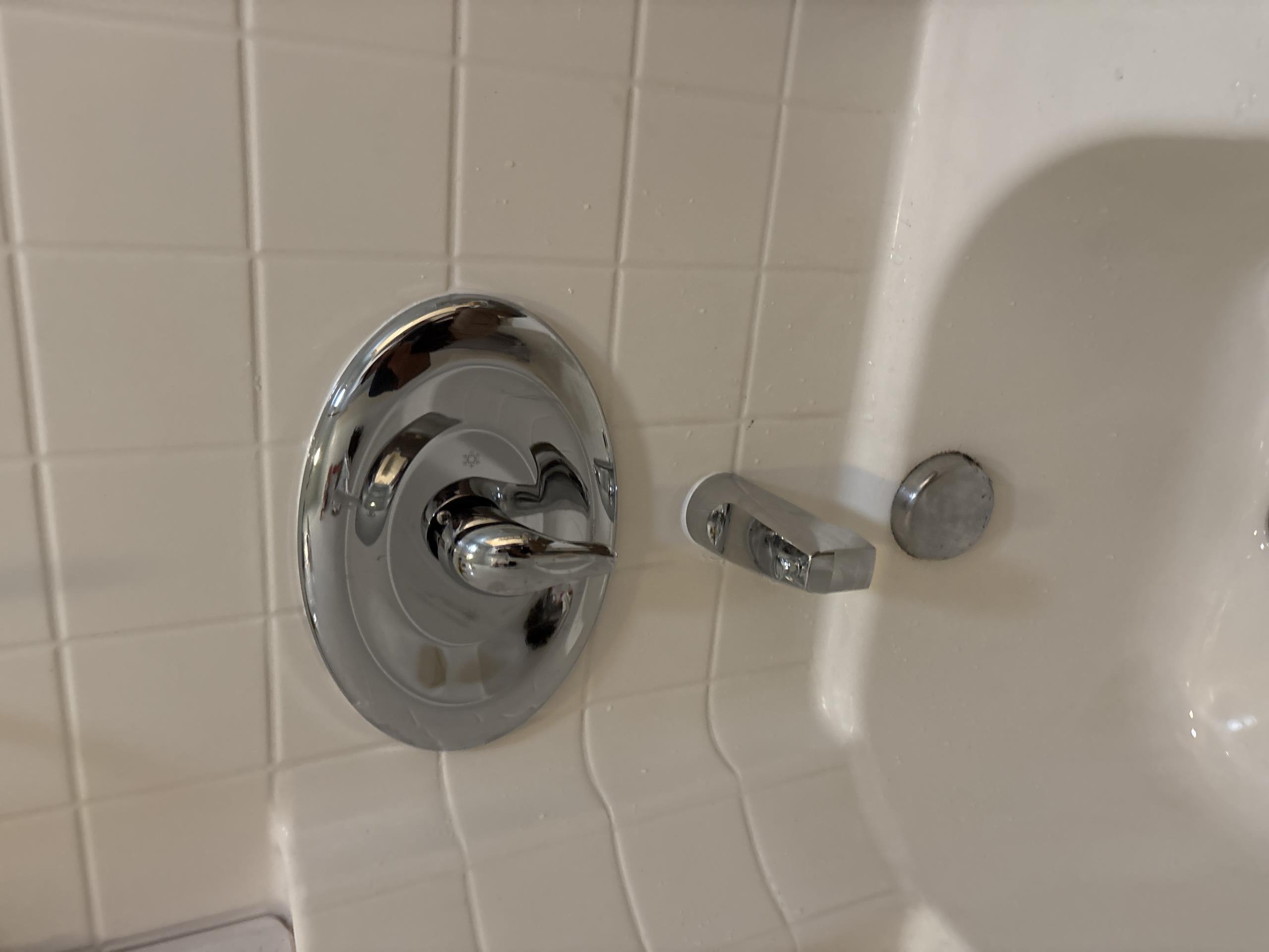 I was called to a customer's home to repair a leaking shower/tub. Upon inspection, I found that the issue was a failed cartridge. I attempted to remove the handle, but the retaining screw was heavily calcified and seized, preventing removal. Due to the condition of the valve and components, a full replacement was necessary.

To access the plumbing, I opened the wall and installed a 6" x 9" cover plate. I removed and replaced the complete shower valve, soldered all connections to ensure a proper seal, and installed a new tub diverter. I restored water service and tested the system for leaks, and cleaned and secured the work area. The warranty for the repair is one year on parts and labor.