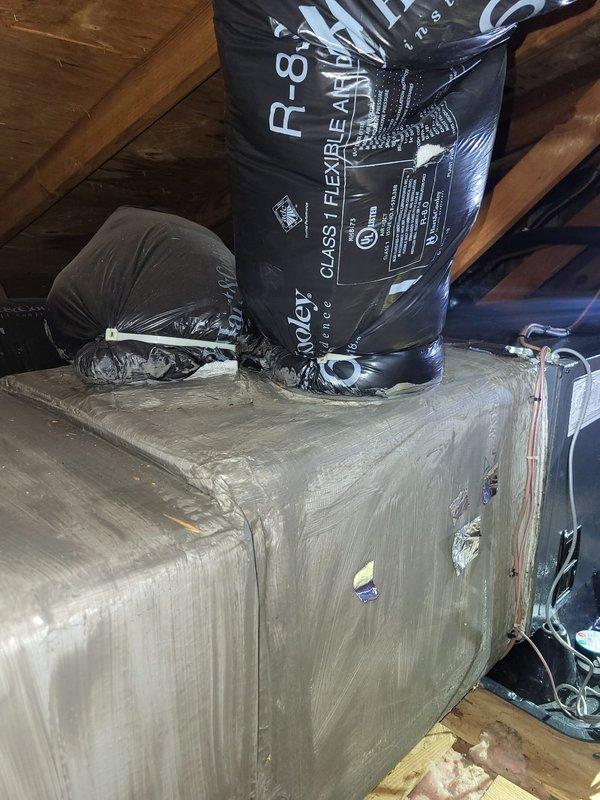 Responded to callback for unit leaking water through ceiling following recent service visit. Conducted thorough inspection of attic-mounted air handler and documented conditions with photos to determine if leak was related to previous work. Found air handler cabinet showing significant deterioration with damaged exterior casing and assessed all condensate drainage components, ductwork connections, and insulation integrity to identify source of water intrusion and establish responsibility for necessary repairs.