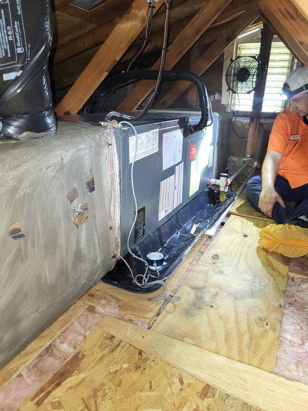Responded to callback for unit leaking water through ceiling following recent service visit. Conducted thorough inspection of attic-mounted air handler and documented conditions with photos to determine if leak was related to previous work. Found air handler cabinet showing significant deterioration with damaged exterior casing and assessed all condensate drainage components, ductwork connections, and insulation integrity to identify source of water intrusion and establish responsibility for necessary repairs.