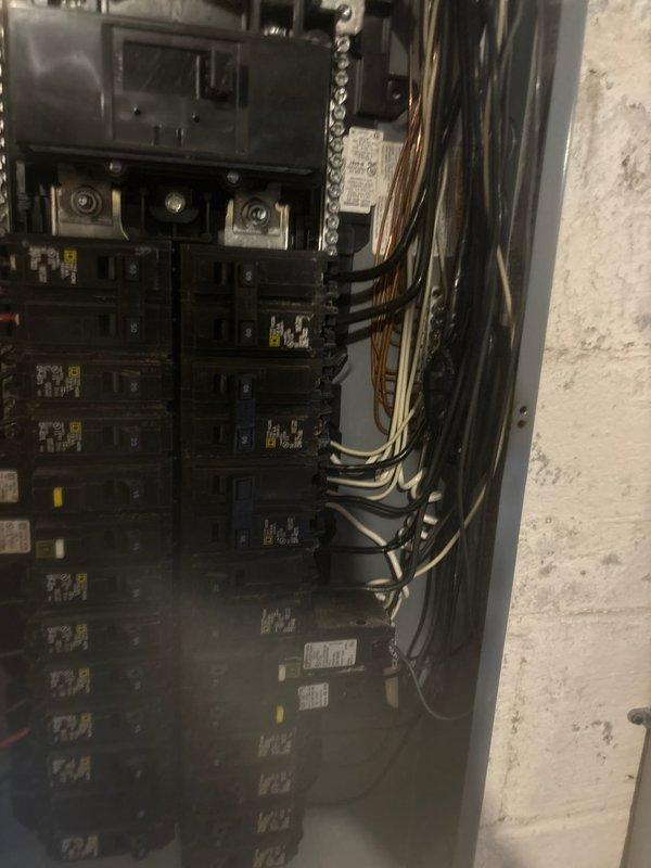 Returned to site to inspect HVAC system installation issues identified during previous visit. Found supply plenum improperly attached to air handler with significant air leakage causing duct wrap inflation—flex collar connection should have been installed between duct system and air handler to prevent air escape. Discovered exposed high-voltage electrical wiring terminated with wire nuts and electrical tape while breaker remained energized, creating immediate safety hazard. Identified undersized heat kit installed compared to original equipment specifications. Documented all findings with photographic evidence and recommended immediate correction of plenum connection, proper electrical termination with breaker de-energization during work, and replacement with appropriately sized 15 kW or 20 kW heat kit to match system heating requirements.