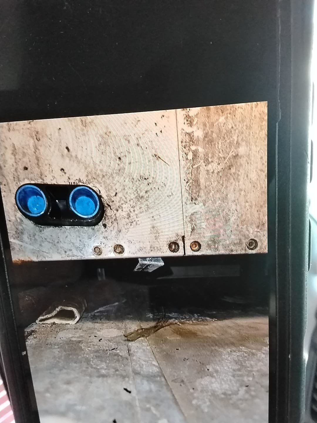 We addressed an issue with water leaking from an air handler that had not been resolved previously. During operation, water dripped from the unit, and the pipe before the trap remained dry until the unit was shut off, at which point a small amount of water was retrieved from the drain. After several attempts, the trap was cleared, and the drain was found to exit about 5 inches below the mulch. To resolve this, we repiped the drain from the unit to the outside above the mulch bed and adjusted the unit's pitch to aid drainage. Additionally, we recommended installing a secondary drain pan measuring 8 feet by 3 feet under the return duct, as there was insufficient space to place it under the air handler.