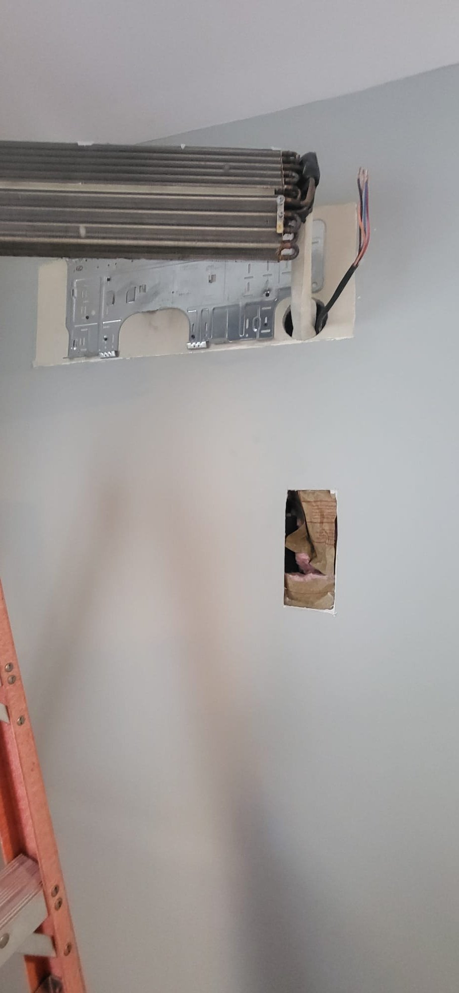 Completed a comprehensive water removal system repair. Evacuated and recovered the R-410A refrigerant, flushed the line set, and removed the failed condensate collection/drain assembly. Accessed the drain line by carefully cutting and removing a section of drywall. Installed a new condensate assembly, flushed the drain line, and verified it was clear and leak-free. Conducted a triple evacuation, achieving a 500 micron vacuum, and recharged with new R-410A refrigerant. Tested the system, ensuring proper operation and performance.