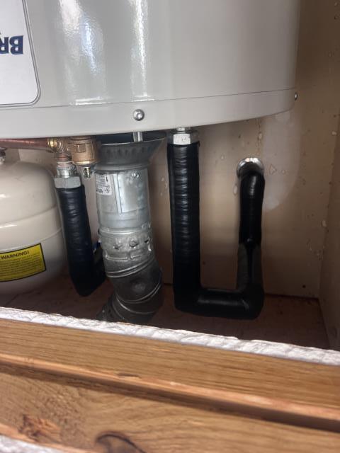 Water heater installation with copper piping and gas line connections, demonstrating plumbing services by American Eagle Plumbing in Leander, TX.