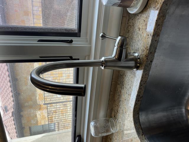 Modern delta laundry faucet installed in a kitchen setting, showcasing sleek design and functionality, relevant to plumbing services by American Eagle Plumbing in Lakeway, TX.