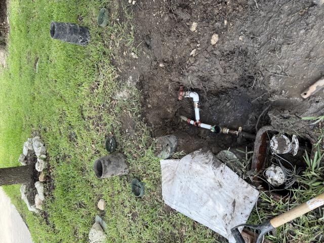 Plumbing repair site showing exposed pipes, tools, and debris in a residential yard, relevant to plumbing maintenance and repairs in Cedar Park, TX.