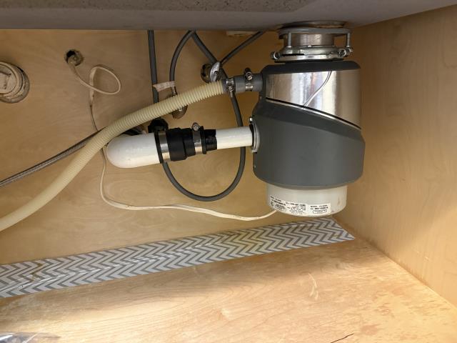 
I replaced an old garbage disposal with  a 1/2 HP Wolverine Brass Garbage Disposal in a kitchen.