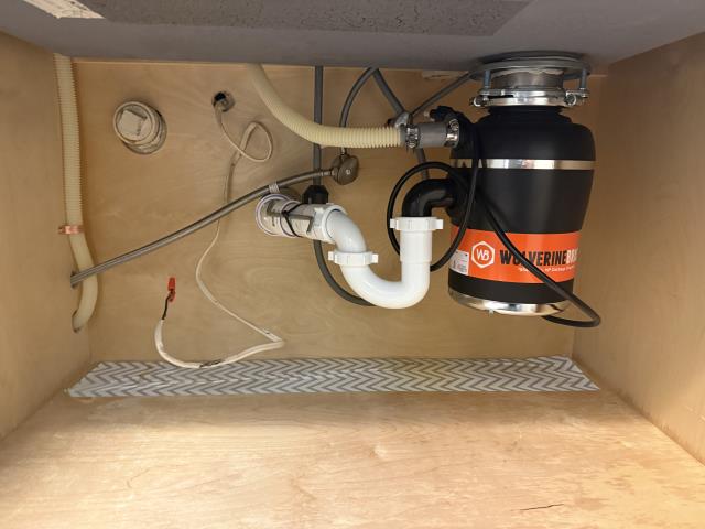 
I replaced an old garbage disposal with  a 1/2 HP Wolverine Brass Garbage Disposal in a kitchen.