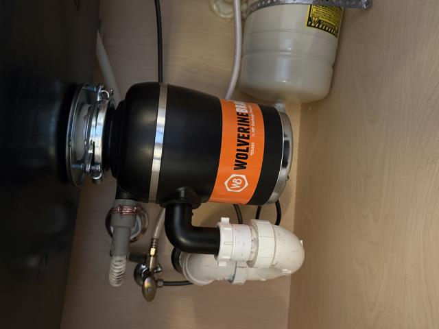 I removed the non-functional garbage disposal and installed a reliable 1/2 HP Wolverine Brass model, ensuring smooth waste processing.