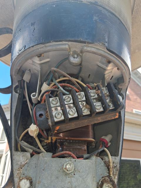 We retrofitted vintage GE lights, preserving their charm while ensuring modern functionality. Installed seven new photocells for efficient operation. Lights now run on 120v, powered by a 208 breaker.