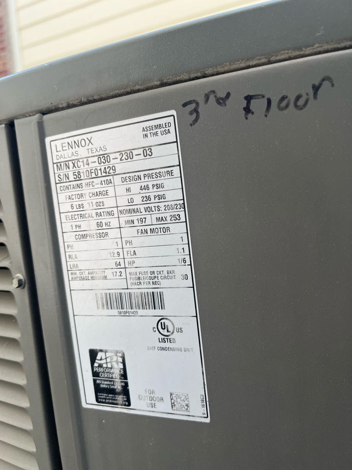Inspecting Lennox AC data plate 