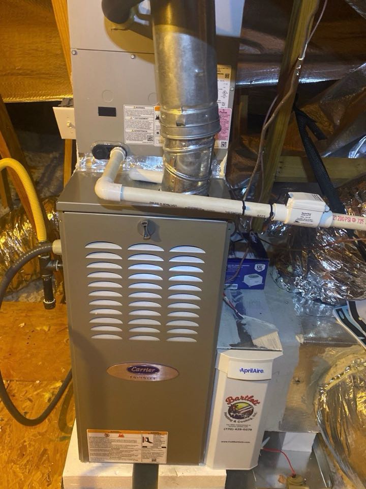 Carrier infinity two stage gas furnace with Aprilaire media filter and drain safety device.