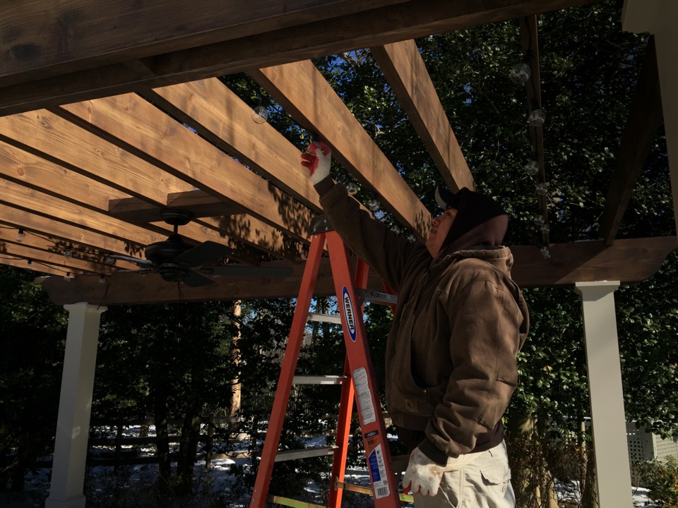 McLean, VA - Here is one of our technicians installing Italian LED bistro string lights under this Pergola in McLean Virginia. McLean, VA - Here is one of our technicians installing Italian LED bistro string lights under this Pergola in McLean Virginia.