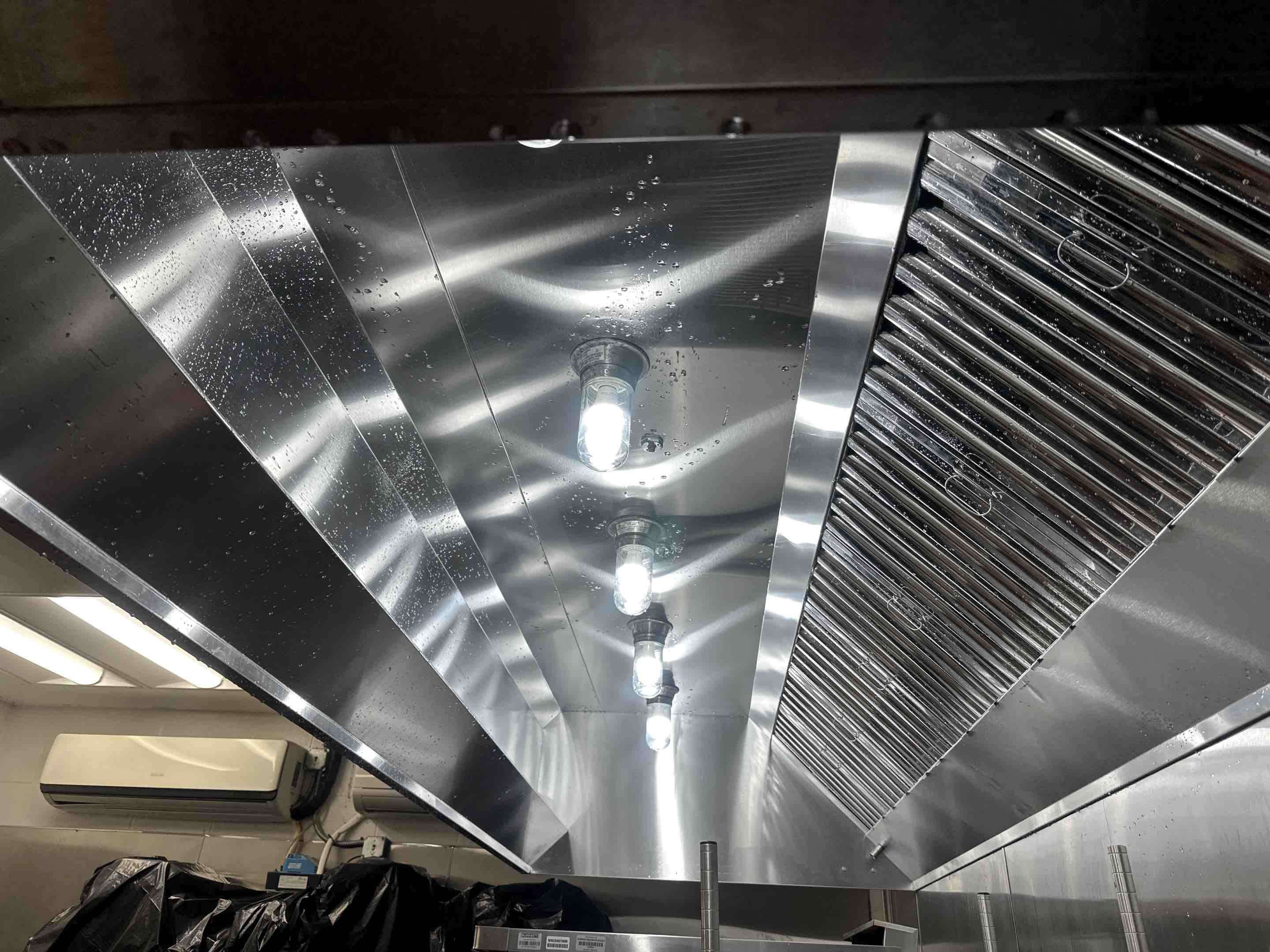A thorough cleaning of the kitchen hood was performed, ensuring optimal performance and hygiene. The process began with a detailed inspection to identify areas requiring attention. The hood's exterior and interior surfaces were meticulously wiped down using eco-friendly cleaning agents to remove grease, grime, and food particles. The grease filters were carefully removed, cleaned, and sanitized. The ductwork was inspected for blockages and cleaned as needed to ensure proper ventilation. Post-cleaning, a final inspection was conducted to confirm that all areas were spotless and functioning correctly. This comprehensive cleaning enhances air quality and maintains a safe environment.