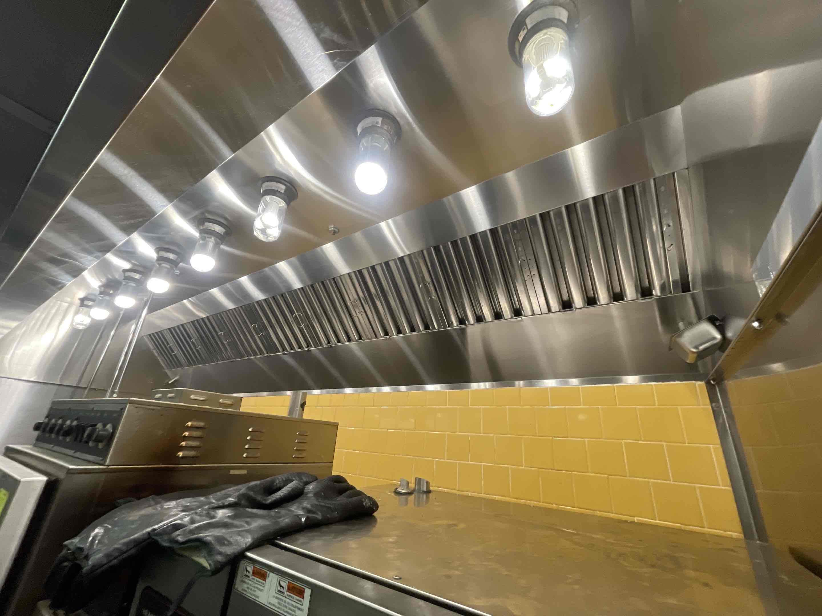 A thorough cleaning of the kitchen hood system was performed for a co-op market. The process began with a comprehensive inspection to identify areas requiring attention. The hood's exterior and interior surfaces were meticulously cleaned, removing grease, grime, and food particles. Special attention was given to the grease filters, which were removed, cleaned, and sanitized. The ductwork was inspected for blockages and cleaned to ensure optimal airflow. The hood's motor and fan were also cleaned and lubrica